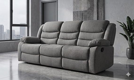 Gray sofa in a modern living room with large windows and a plant.