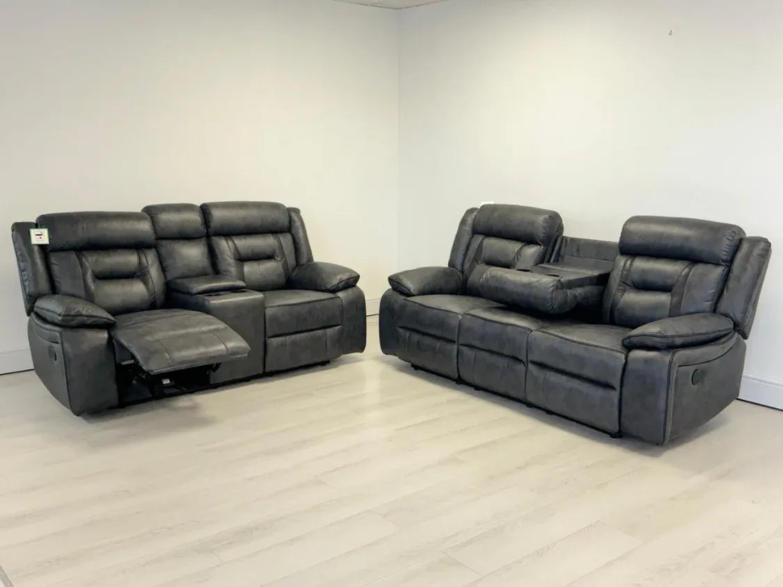 Gray reclining sofa set in a room with white walls and floor.